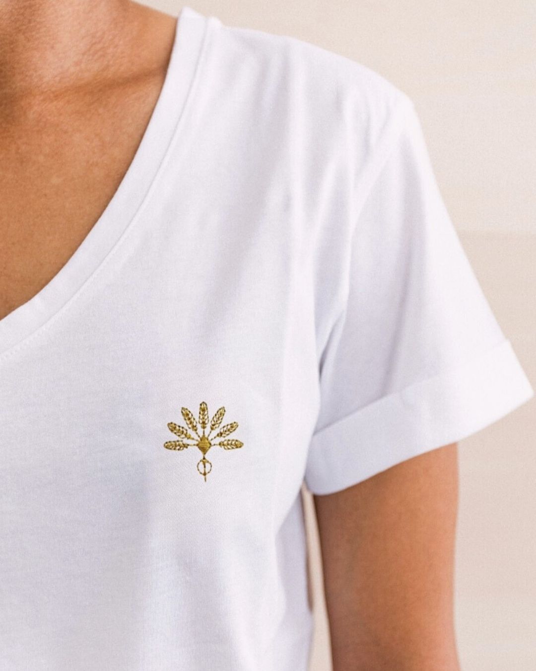 Tee-shirt signature brodé Soamarena blanc, col V, logo doré, porté.
